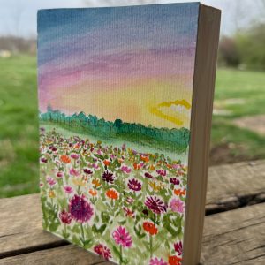 Watercolor painting of zinnia field at sunset mounted on wood
