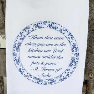 Folded white tea towel with Saint Teresa of Avila quote in blue