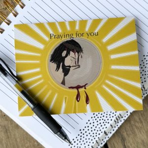 "Praying for You" card showing image of Jesus in the Monstrance. Pen for scale.