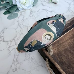 Knotted headband featuring the image of Fulton Sheen speaking into a microphone on a dark green background.