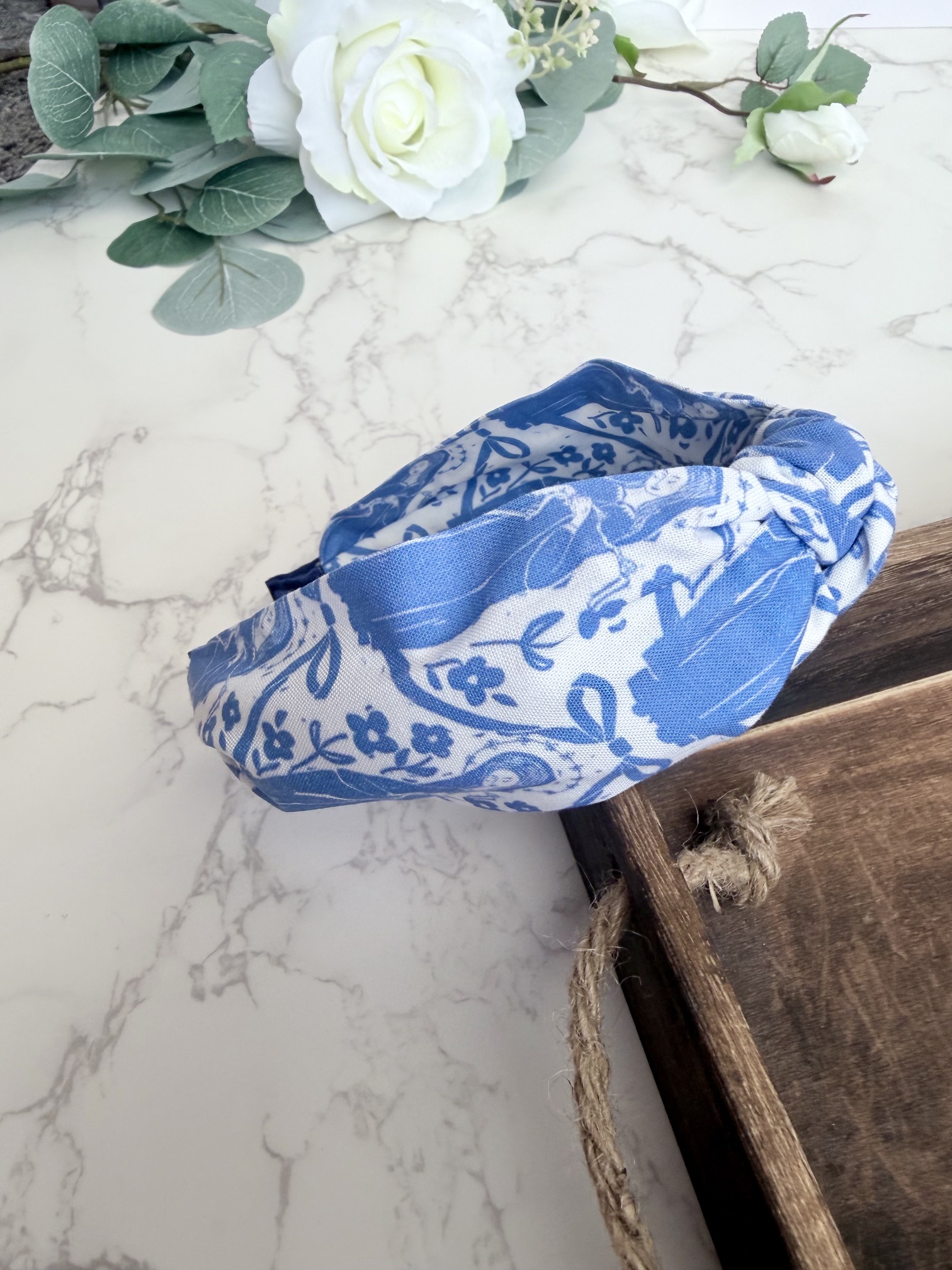 Knotted headband featuring the image of Our Lady Undoer of Knots in blue on a white background.