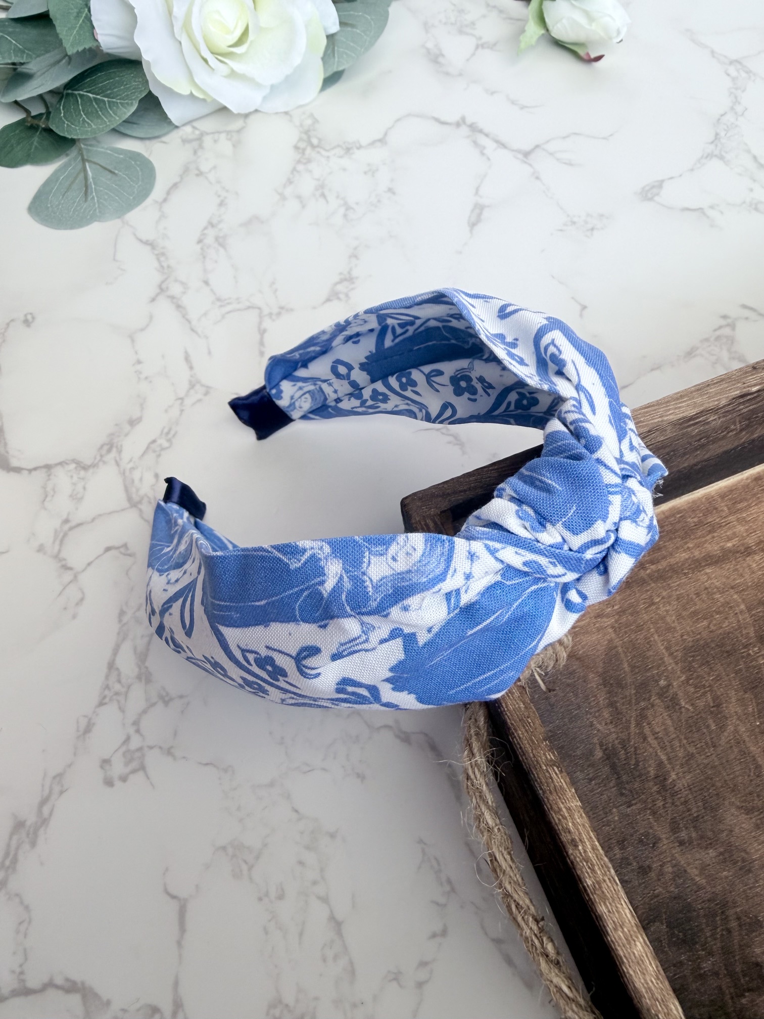 Knotted headband featuring the image of Our Lady Undoer of Knots in blue on a white background.