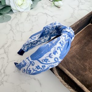 Knotted headband featuring the image of Our Lady Undoer of Knots in blue on a white background .